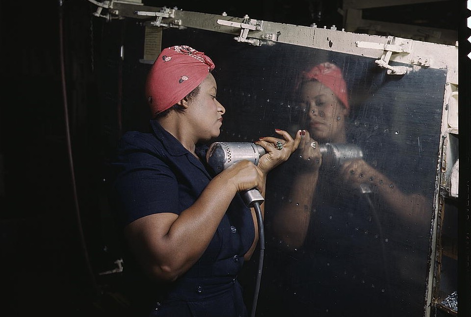 Operating a hand drill at Vultee-Nashville, woman is working on a "Vengeance" dive bomber, 1943