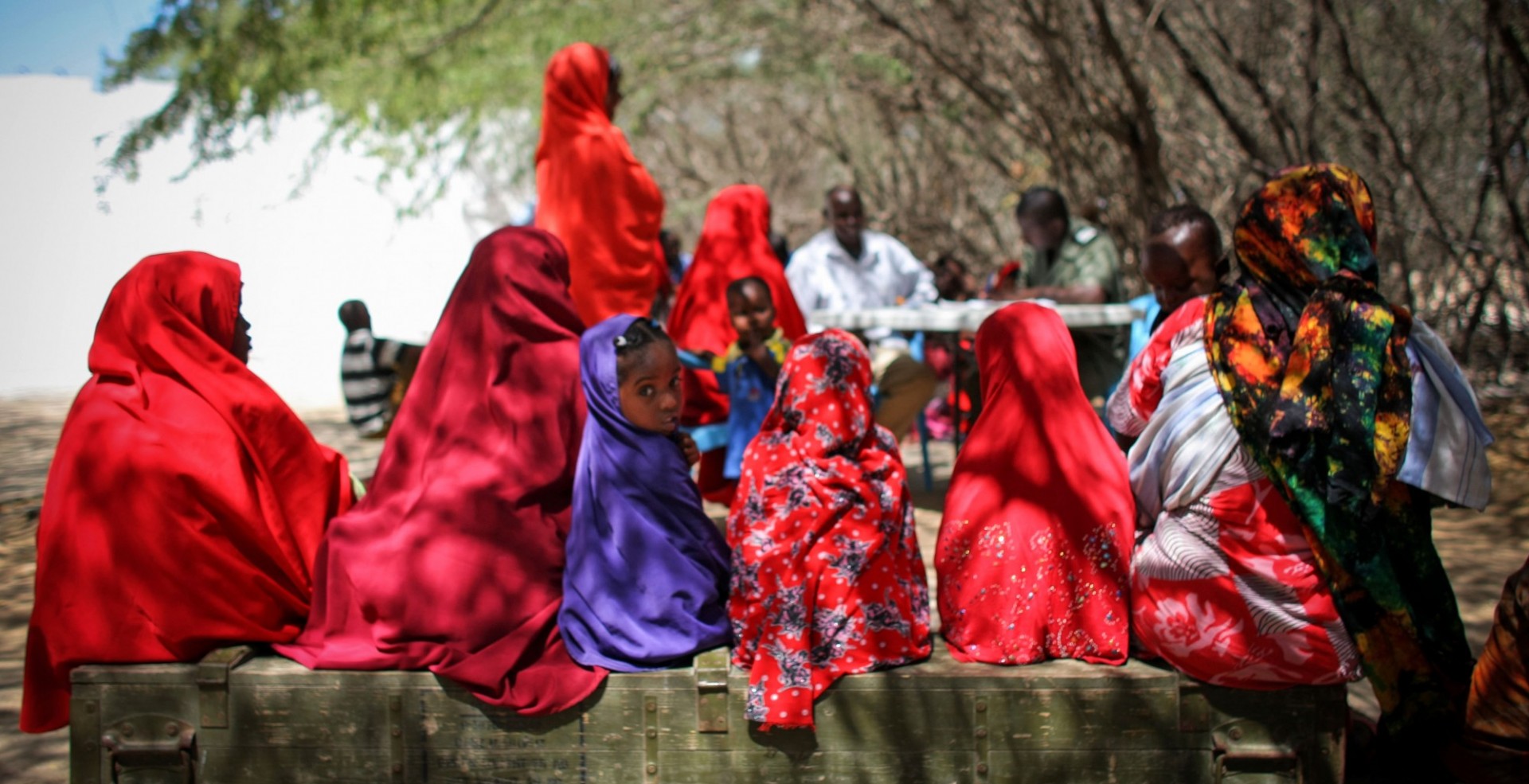 Somali women and girls wait to see a Burundian medical officer serving with the African Union Mission in Somalia