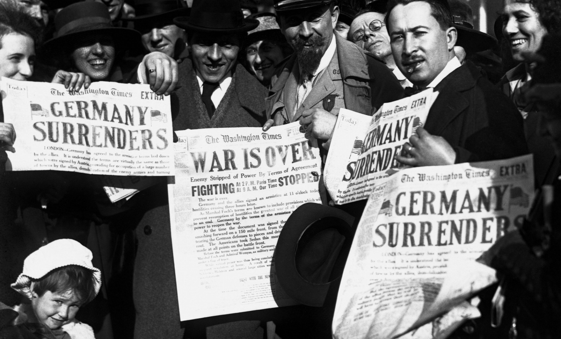 ewspaper headlines which announce the surrender of Germany, ending World War I, November 8, 1918.