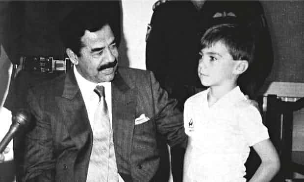 Saddam Hussein with five-year-old Stuart Lockwood, one of the hostages held as "human shields" by the dictator. Source: /Rex Features, on The Guardian: "That’s me in the picture: Stuart Lockwood with Saddam Hussein, 24 August 1990 Baghdad, Iraq" (5 Jun. 2015).