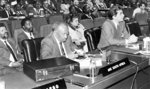 Alfred Nzo, Secretary General of the ANC; behind him is Stanley Mabizela (left) and Thabo Mbeki (right), at a meeting of Afro-Asian People's Solidarity Organisation (AAPSO) in the late 1970s. Source: African National Congress (ANC).