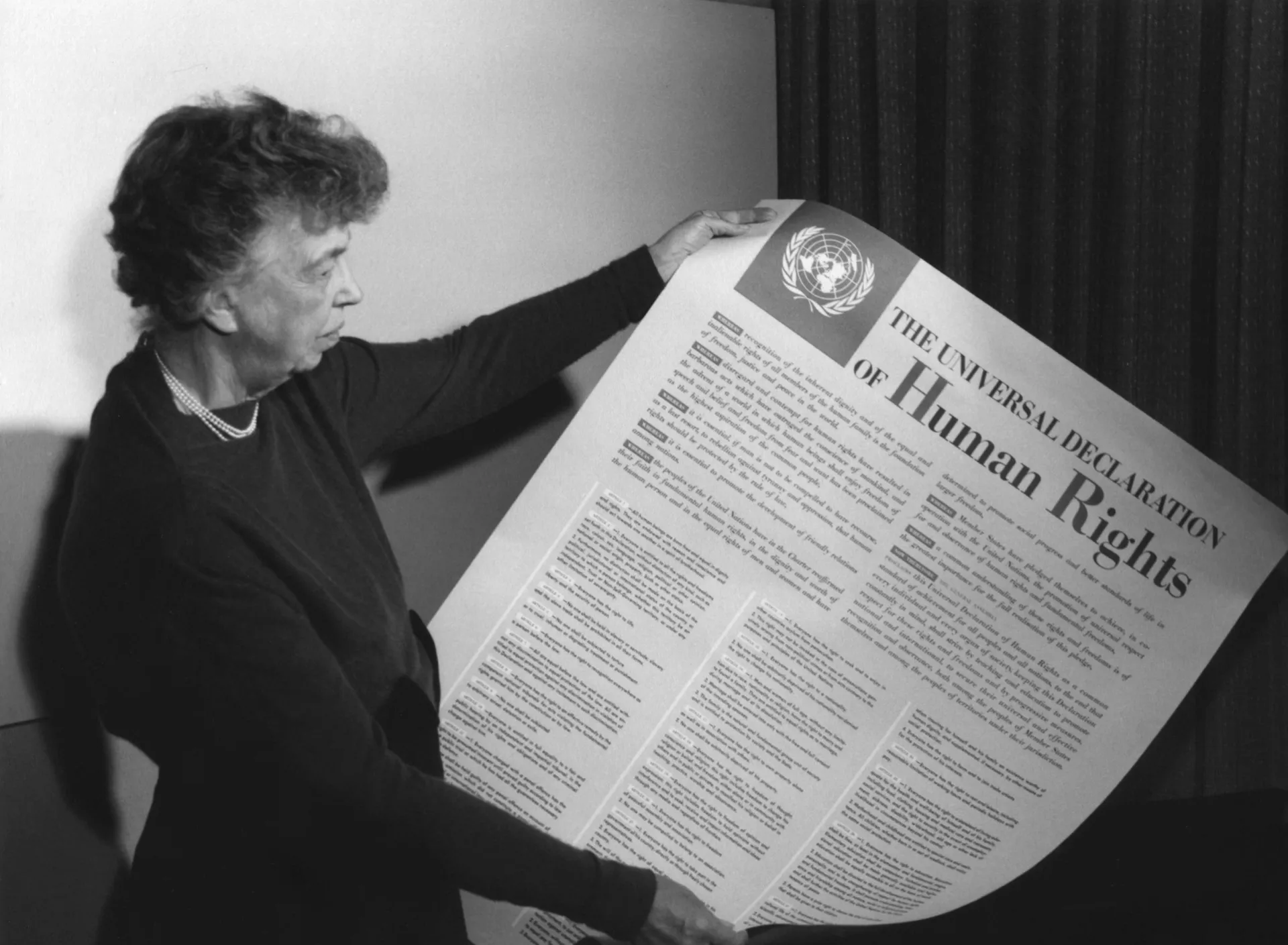 Eleanor Roosevelt holding poster of the Universal Declaration of Human Rights, Lake Success, New York. November 1949.