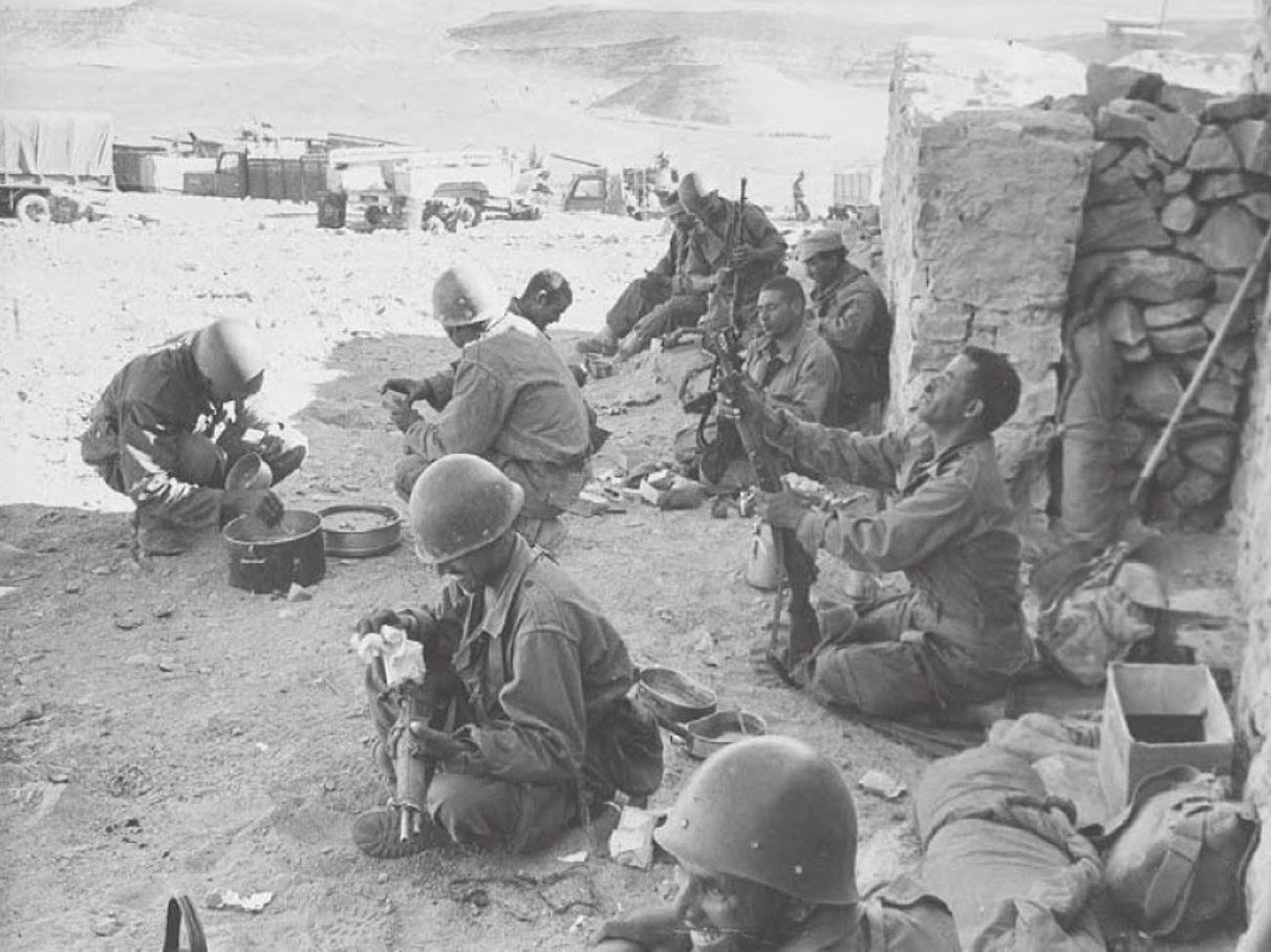 Moroccan soldiers sit in the shade cleaning their weapons and preparing food during a lull in border fighting against Algerian troops, near Tindouf in southwestern Algeria, November 4, 1963. (AP/Wide World Photos) (Source: Student dissertation)